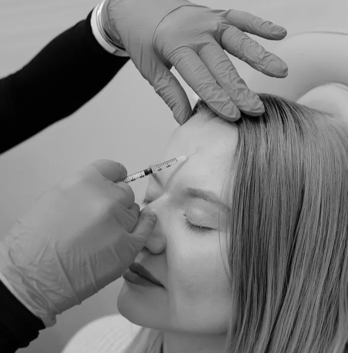 Woman getting injection in forehead